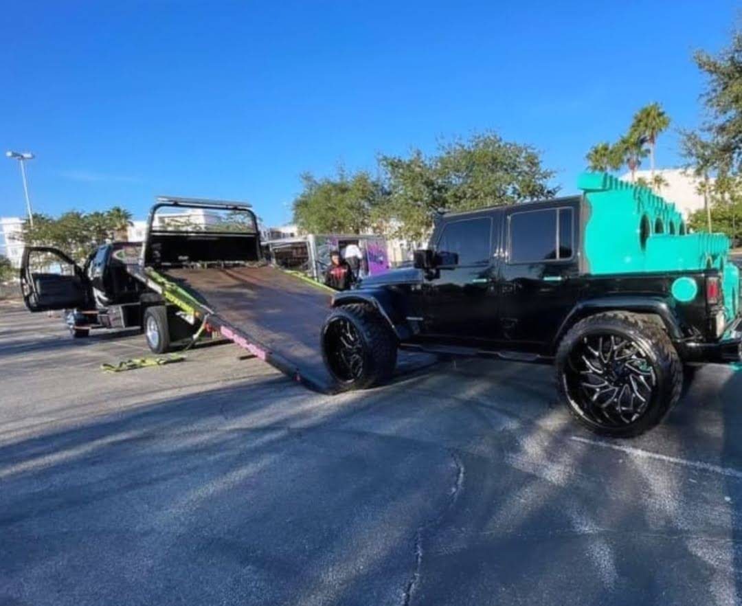 Lifted Jeep being loaded onto a Yayi’s Towing flatbed